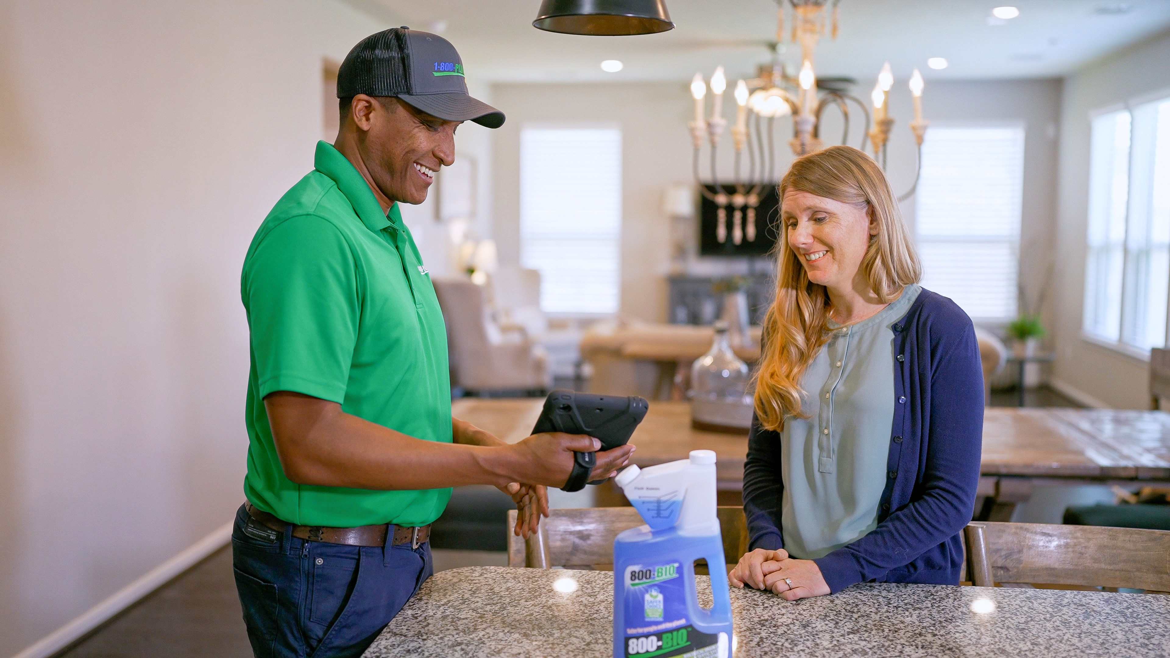1-800-Plumber +Air technician servicing fixtures in a home